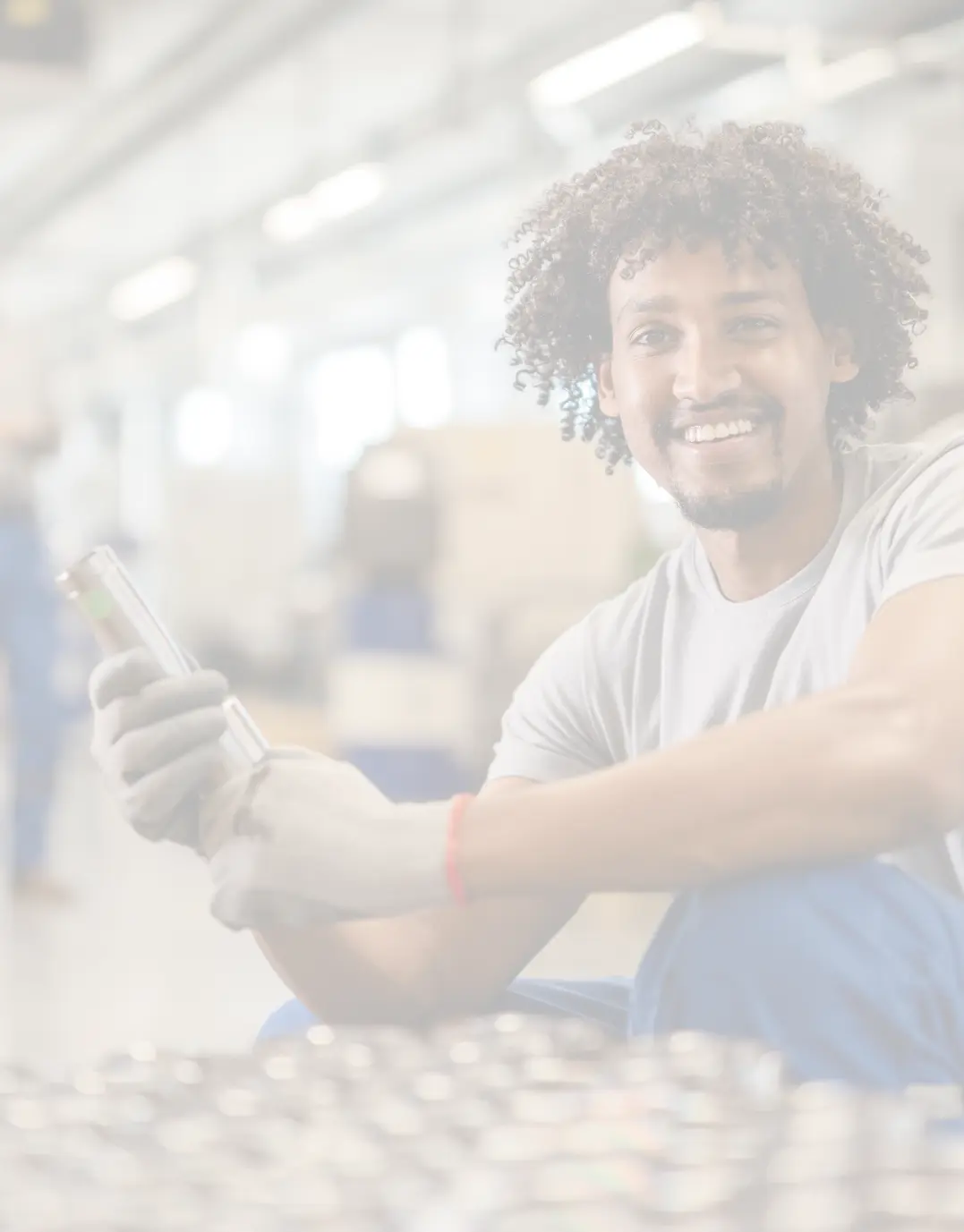 Happy plastics manufacturing worker inspecting some equipment while smiling into view.
