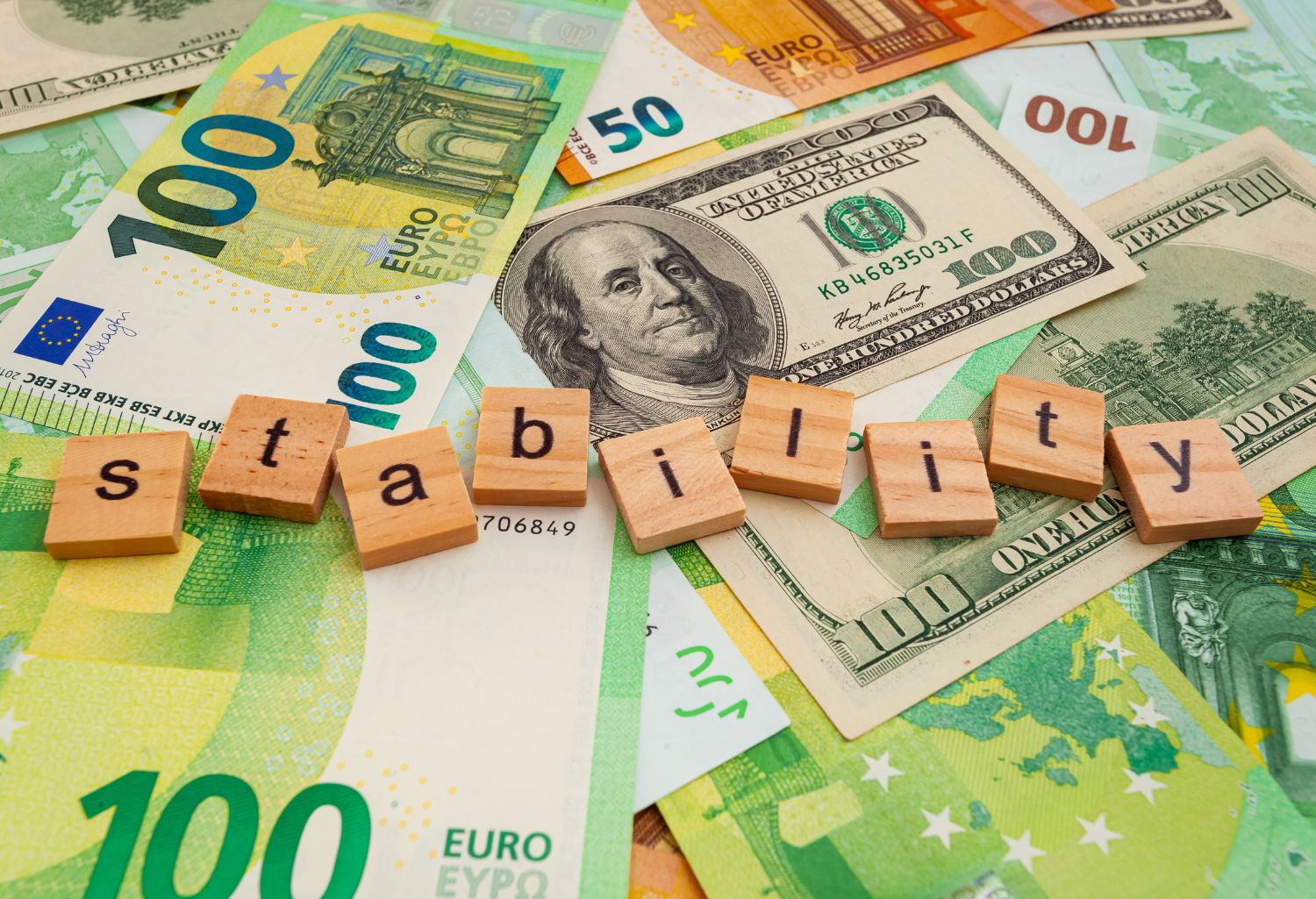 Financial Stability for Plastics Companies inscription on wooden cubes on the texture of us dollars euro banknotes.